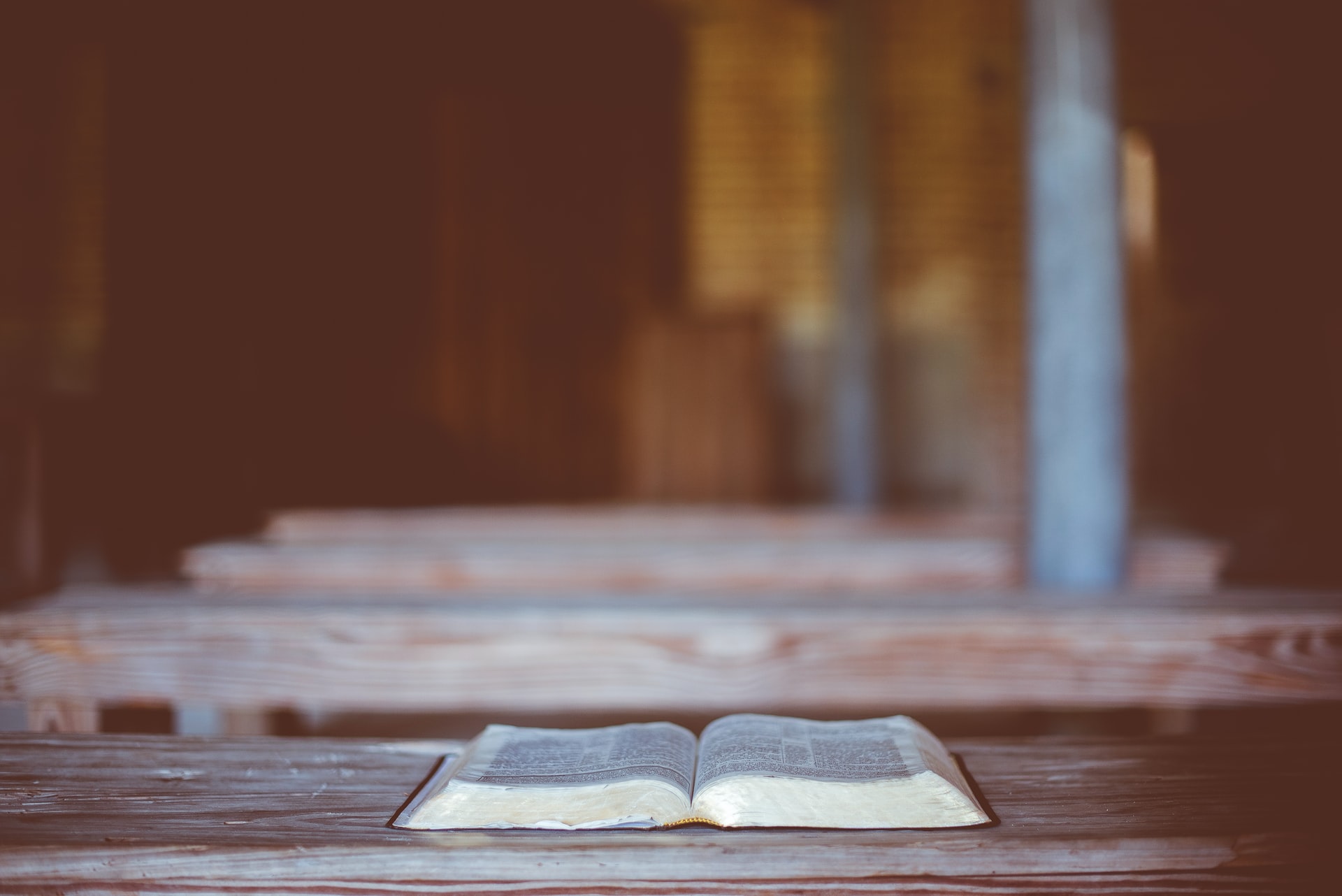 open bible on wooden bench